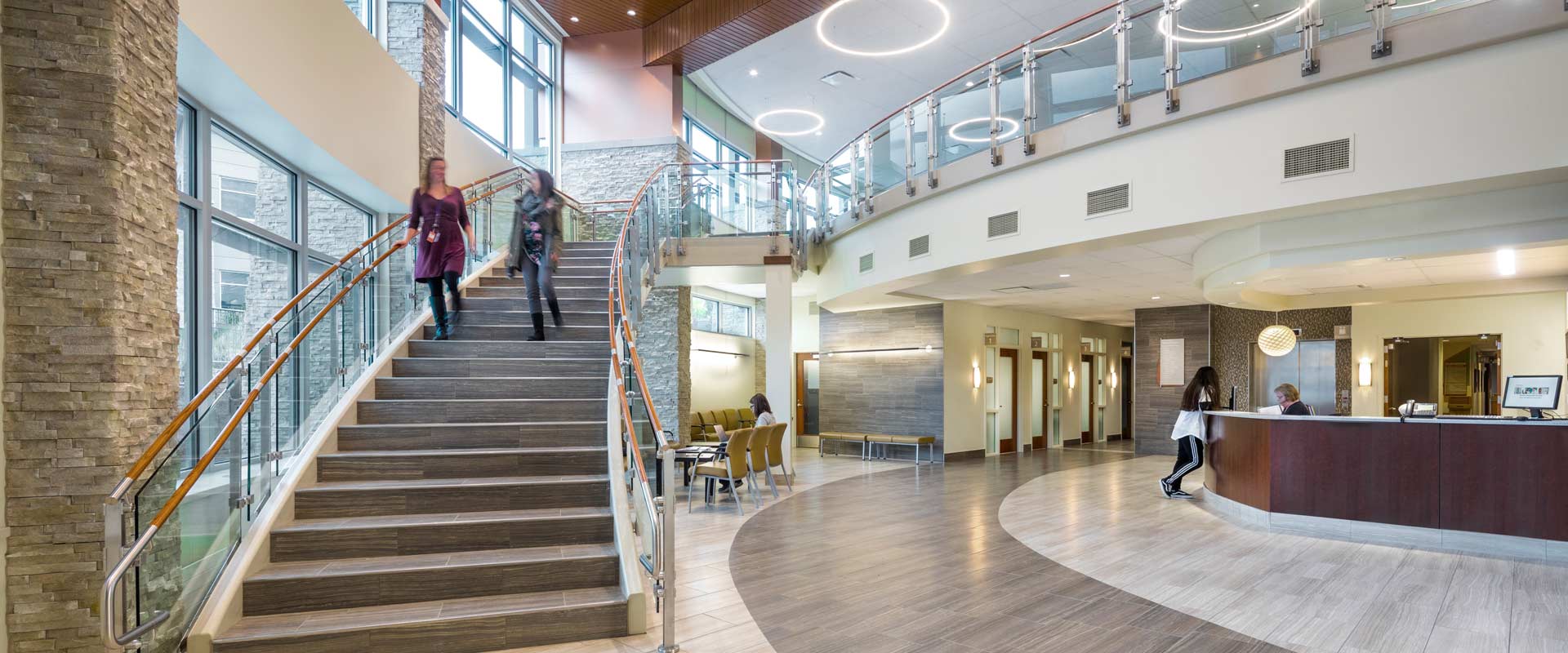 photo of the main lobby at southwest memorial hospital. people are checking in and waiting in the waiting area