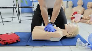 Photo of someone performing CPR on a practice dummy in a CPR Class